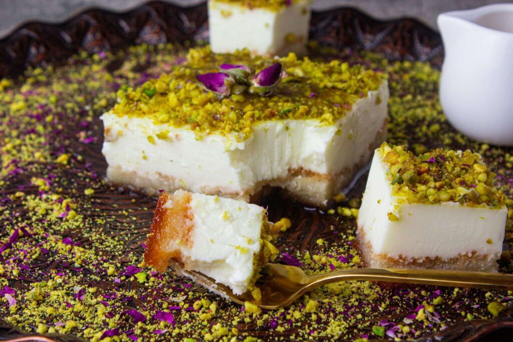 Aish El Saraya Dessert is garnished with pistachios, a layer of soaked crusty toast bread that melts in the mouth along with a creamy orange blossom topping.