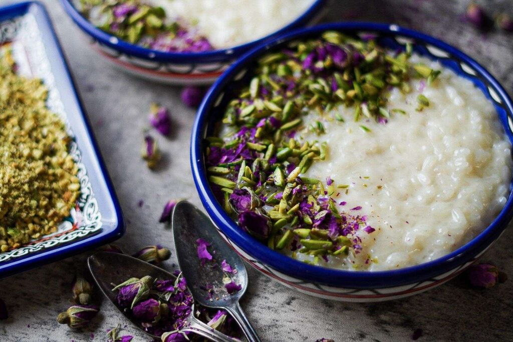 Middle Eastern Rice Pudding bowl served with colorful toppings