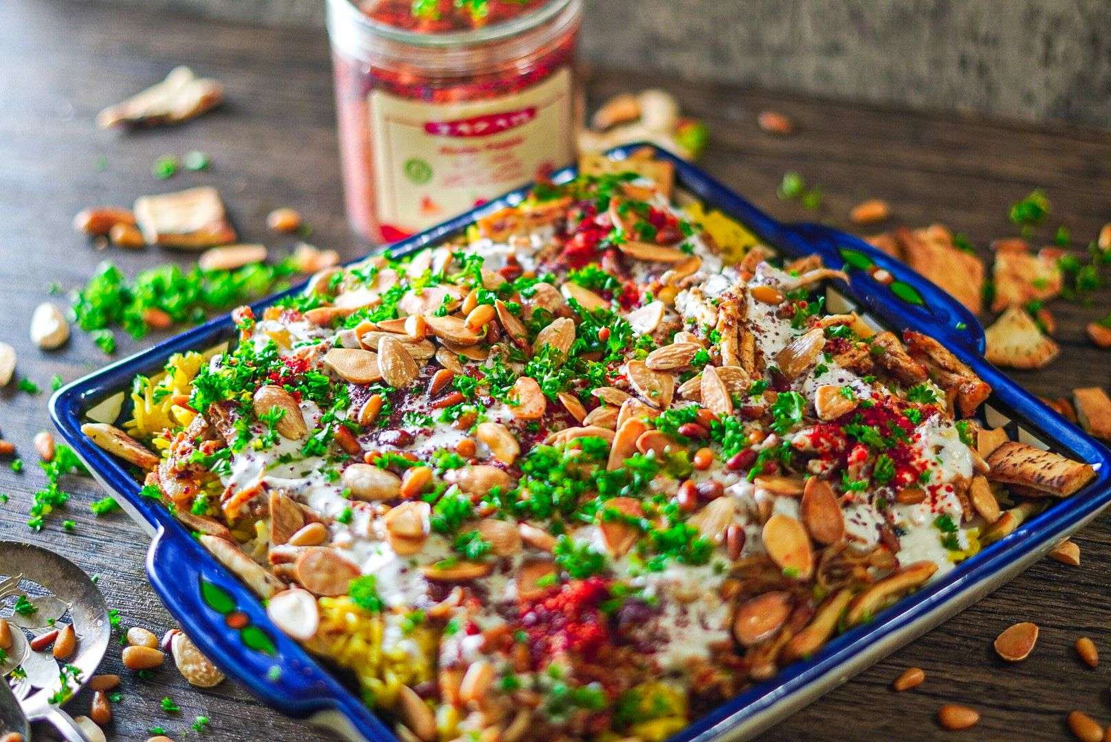 Chicken Fatteh with crunchy nuts and a bed or rice