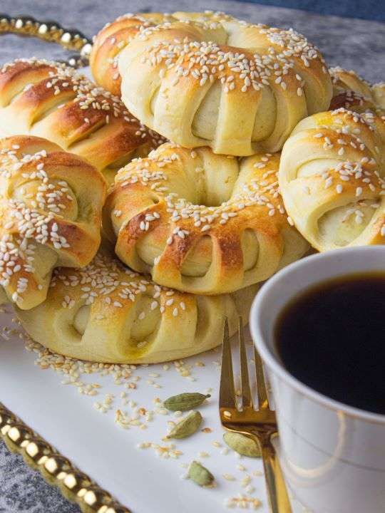 A golden assortment of finely stacked brioche buns with a cup of your coffee
