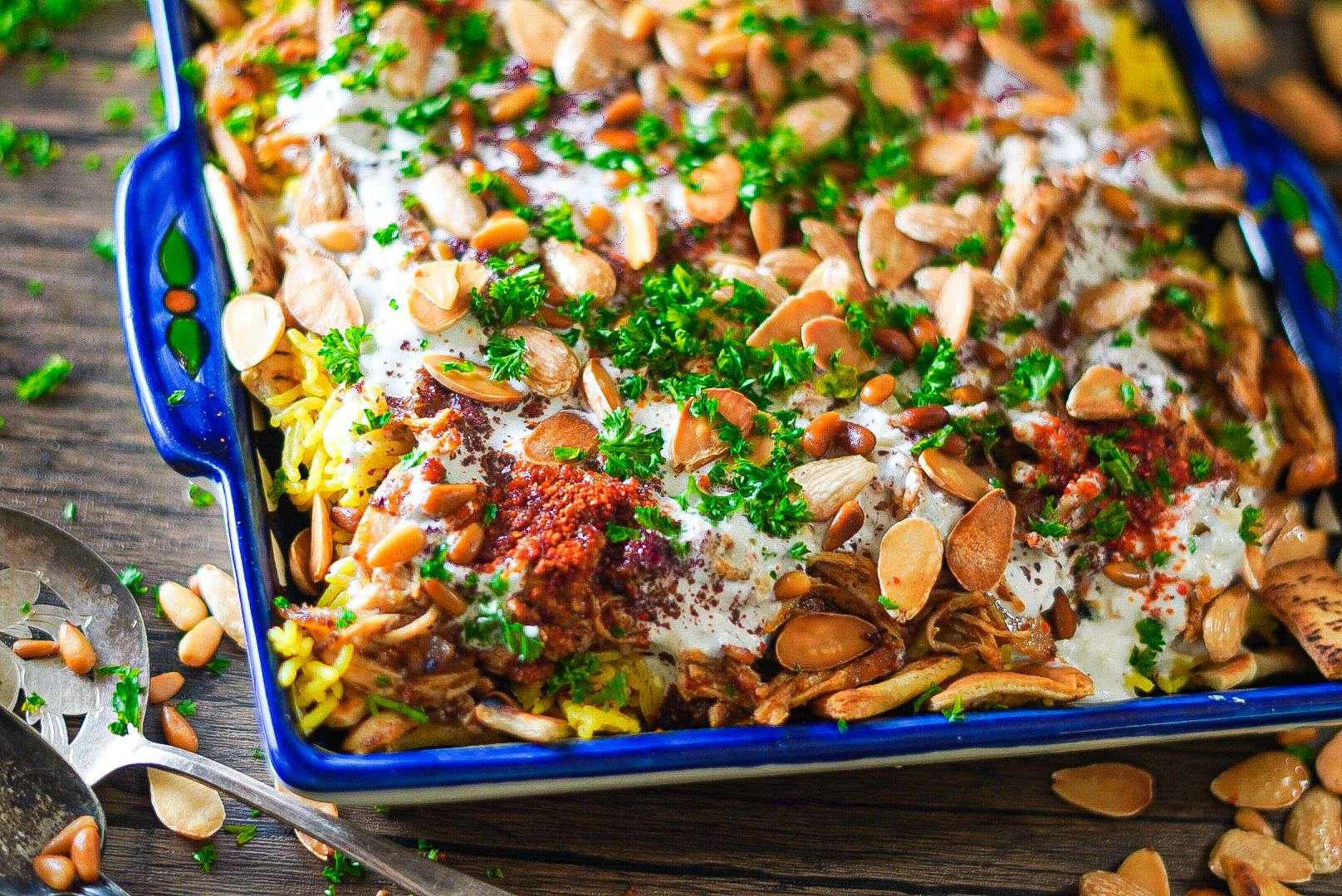 Chicken Fatteh with garlicky yogurt, pita bread, rice, shredded chicken, and garnished with delicious crunchy nuts will make you devour it from the first bite!