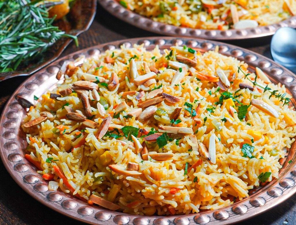 fluffy vegetable rice pilaf made up of Sella basmati rice and different veggies topped with toasted almonds and parsley before serving