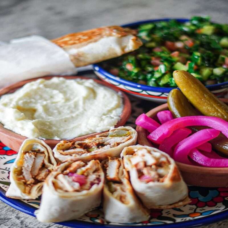 middle eastern shawarma wraps made up with tender chicken pieces marinated in a delectable yogurt marinade and hearty spices. Serve these wraps with cucumber and turnip pickles, tabbouleh, and garlic dip