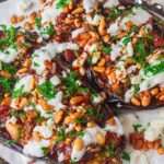 delectable Vegetarian Loaded Eggplants with the perfect mixture of tomatoes and onions, crispy pomegranate stuffing and spicy and spicy yogurt
