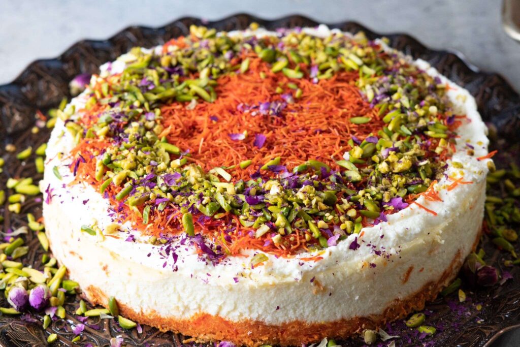 homemade refreshing knafeh cheesecake topped ricotta cheese and garnished with chopped pistachios and rose petals