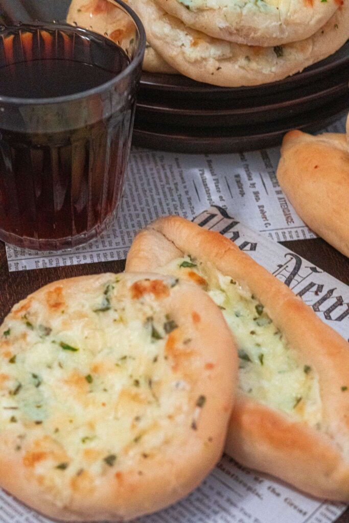 Middle Eastern fatayer made with ten minute dough and s special cheese filling served with zaatar pies and a glass of tea