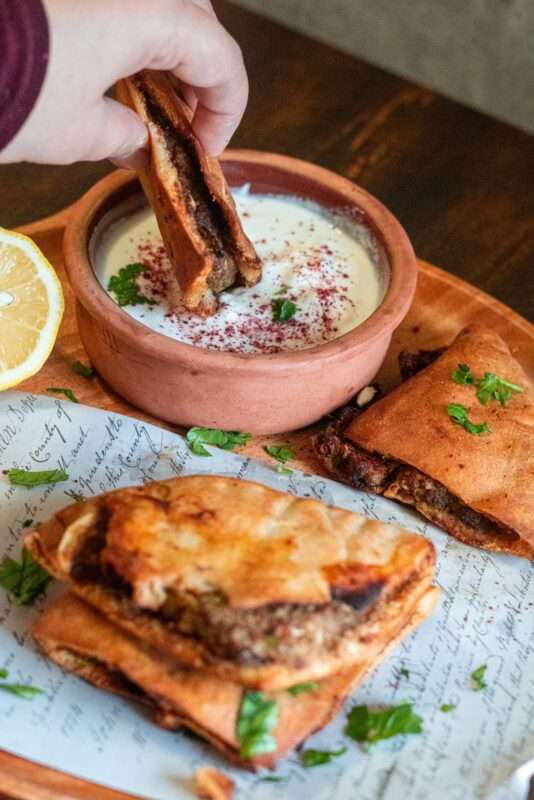 Grilled crispy pita pockets stuffed with tender ground beef mixture and served with yogurt, tahini, or fresh salad on the side.