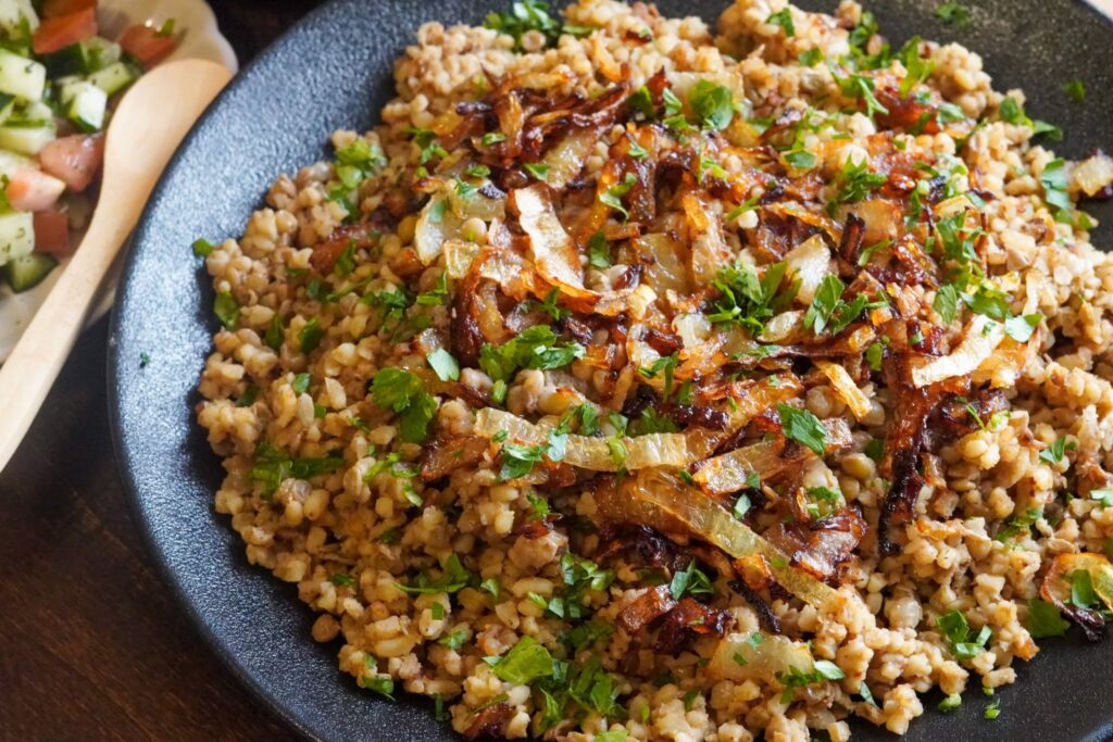 Easy to prepare Burghul Mujadara garnished with caramelized onions and parsley.