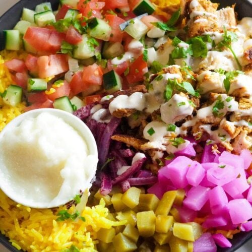 A bed of fragrant, fluffy rice provides a base for the shawarma, absorbing the savory juices and spices, creating a harmonious balance.