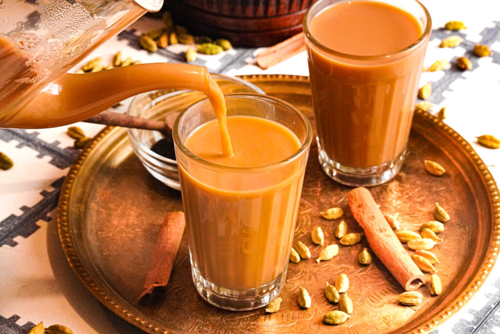 Two cups of Karak chai spiced with cardamom and cinnamon