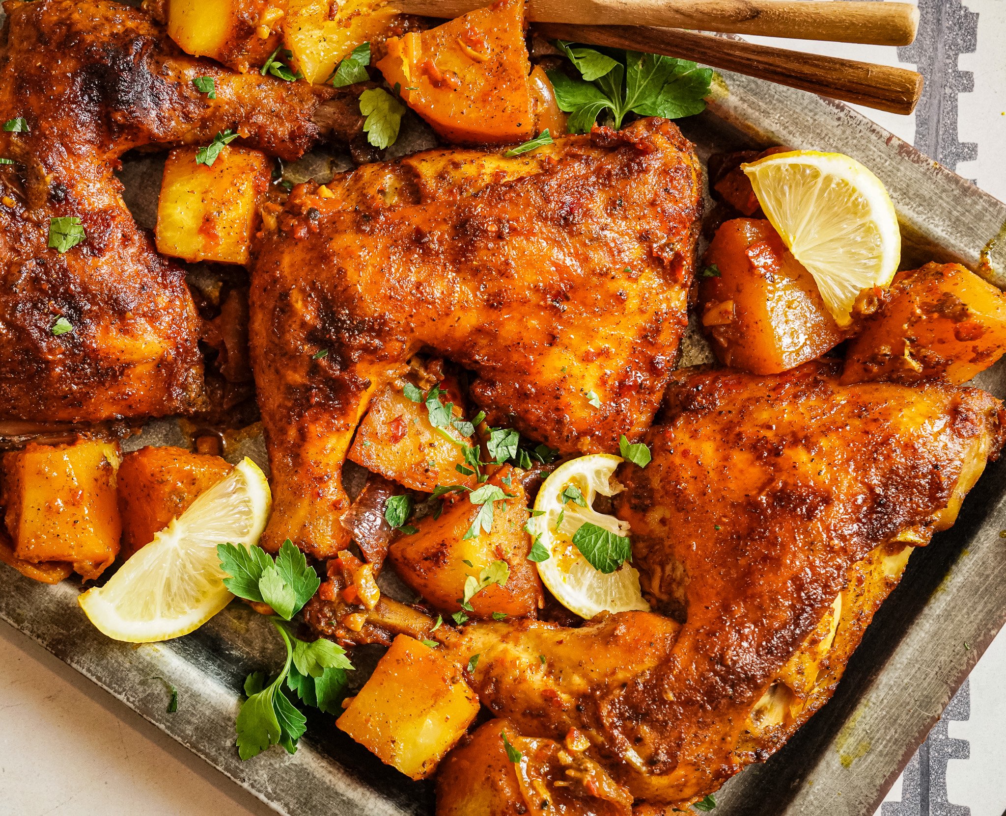 Golden juicy baked chicken with baked potatoes on the side