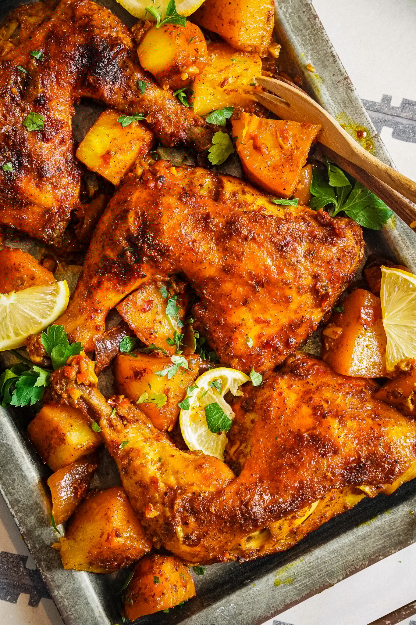 Golden baked spiced chicken, served with baked potatoes for a balanced healthy meal. 