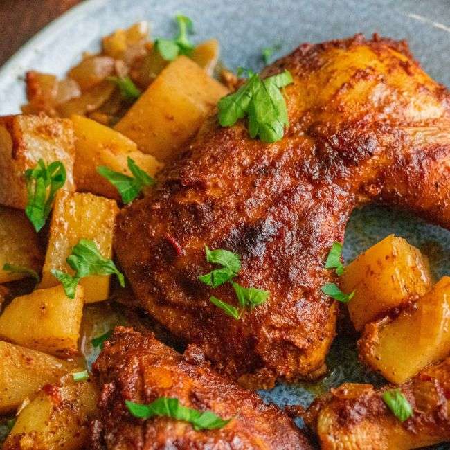 Juicy baked chicken with crispy chicken cooked with yellow potatoes