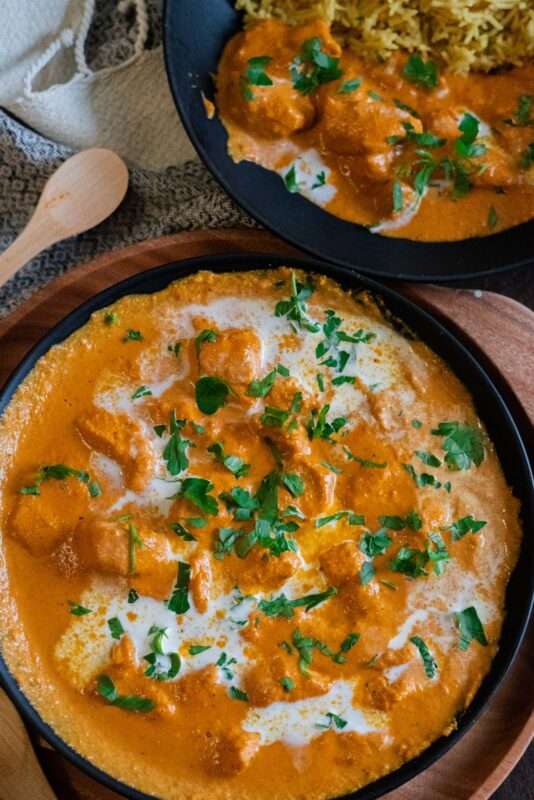 Creamy butter chicken recipe served with chopped parsley.