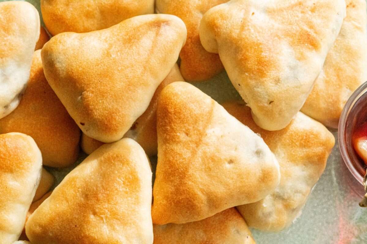 Triangular pies filled with a well-seasoned mixture of onions and sbanekh and baked until golden