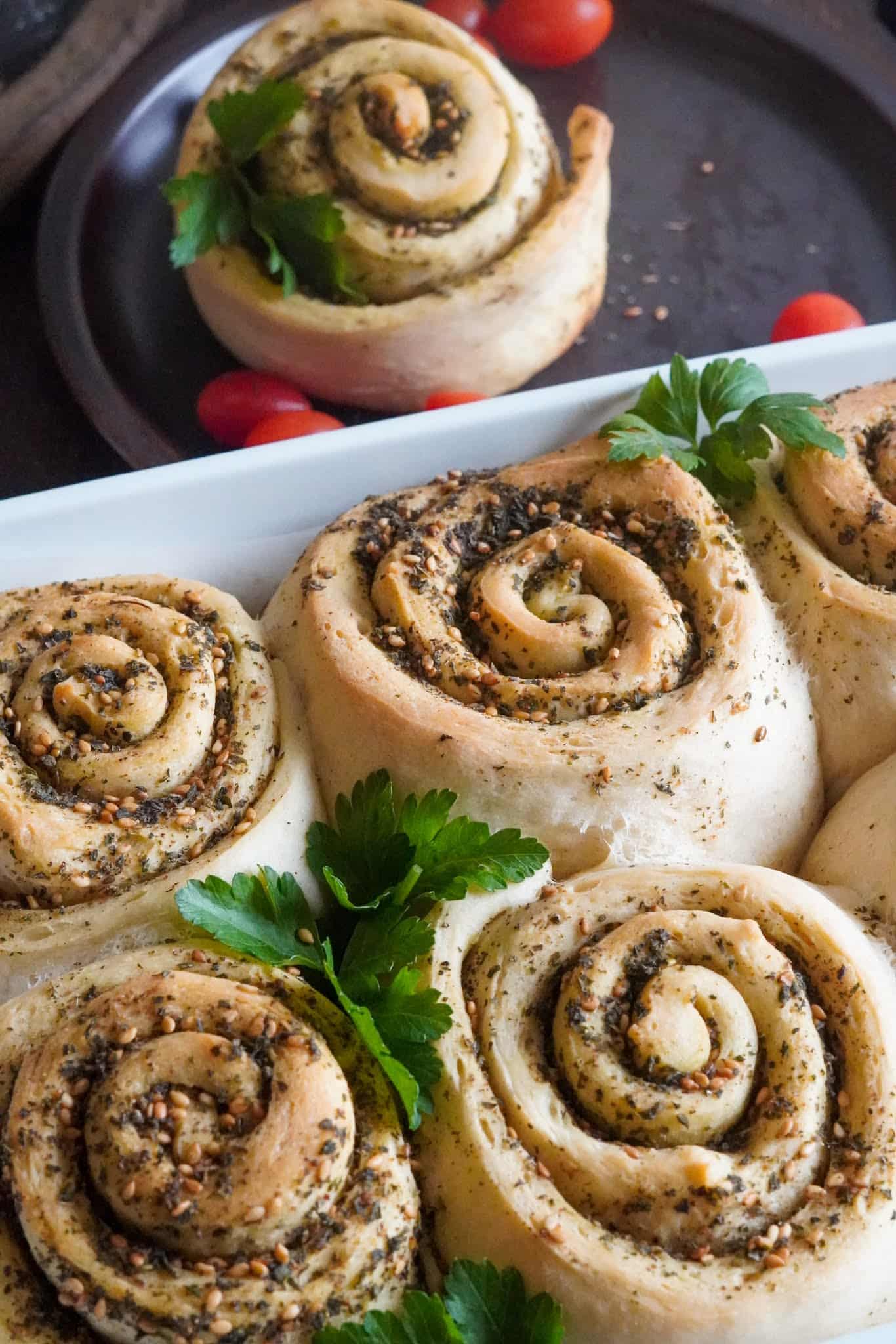 Bread rolls stuffed with za'atar decorated with parsley leaves.