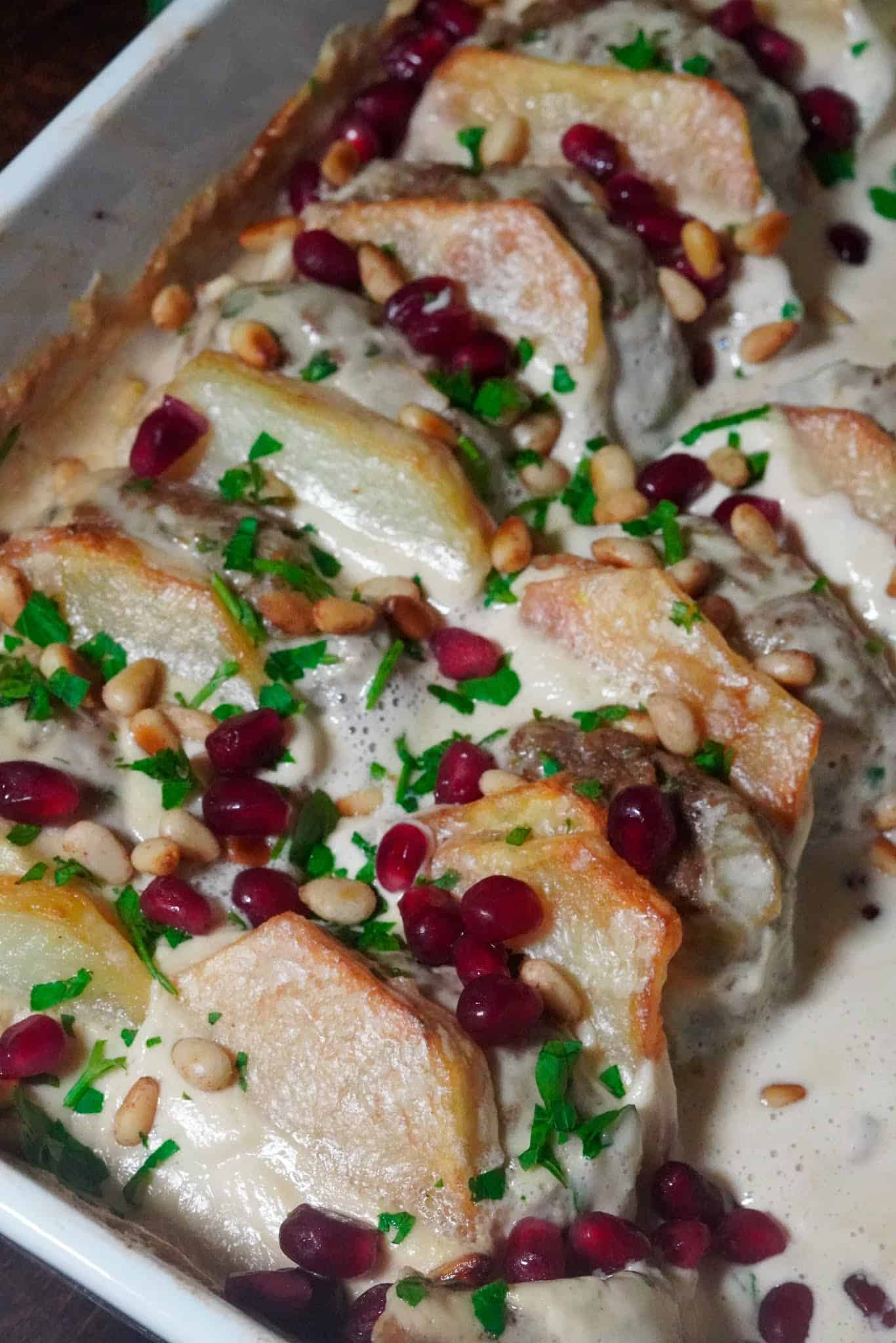 Kufta bil Tahiniye sprinkled with parsley and pomegranate