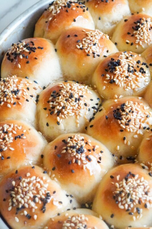 golden beehive sweet buns topped with sesame seeds and Nigella seeds