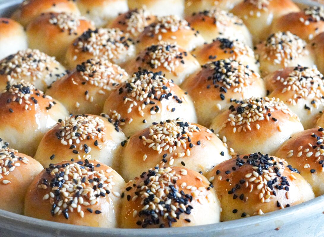 honeycomb bread baked to golden perfection topped with sesame seeds and Nigella seeds and drizzled with honey before serving