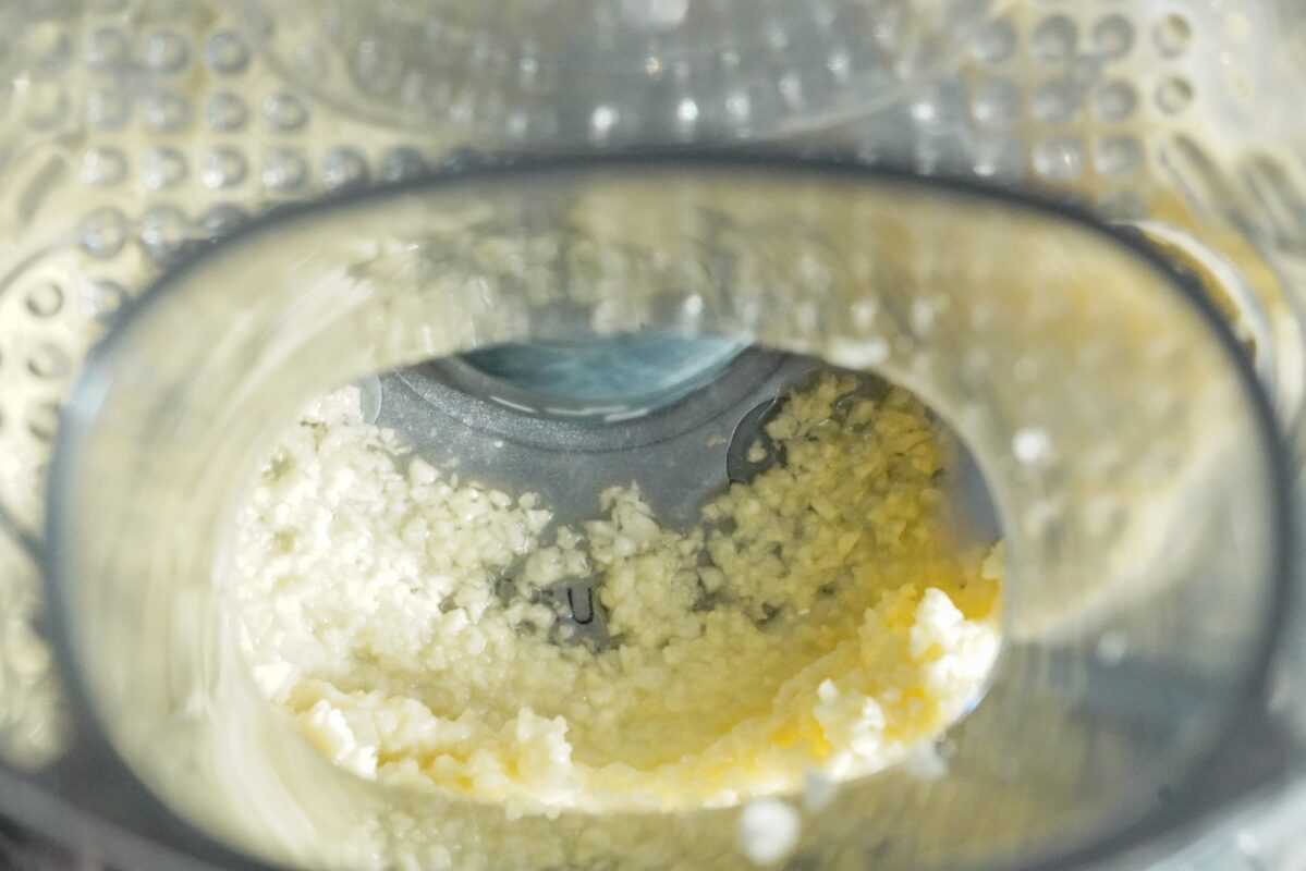 Close the lid, and add the emulsion sleeve to your food processor. 