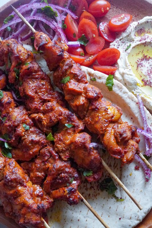 The chicken are shown as four with a side of hummus mtabal.