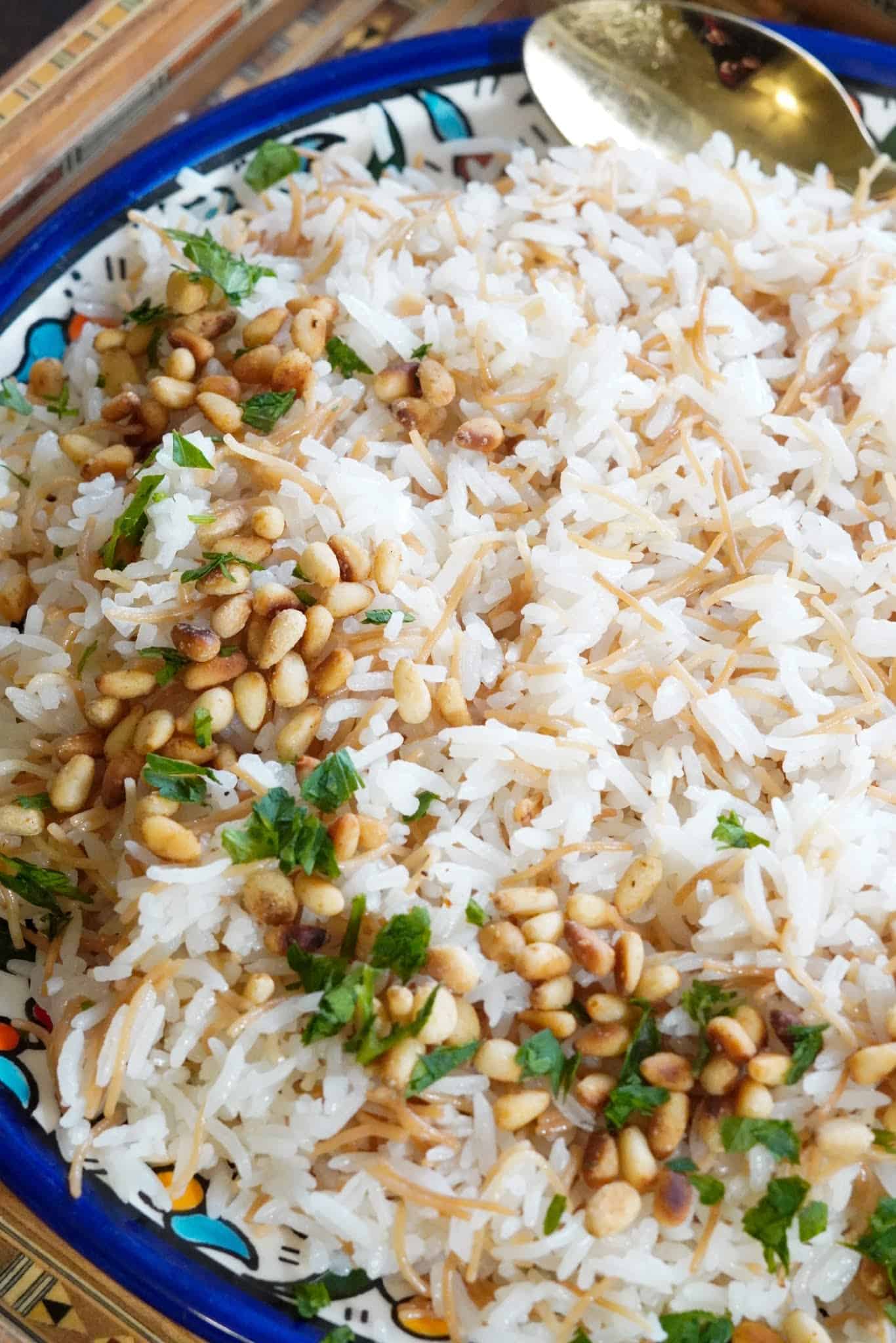 A generous plate of vermicelli rice garnished with toasted pine nuts.