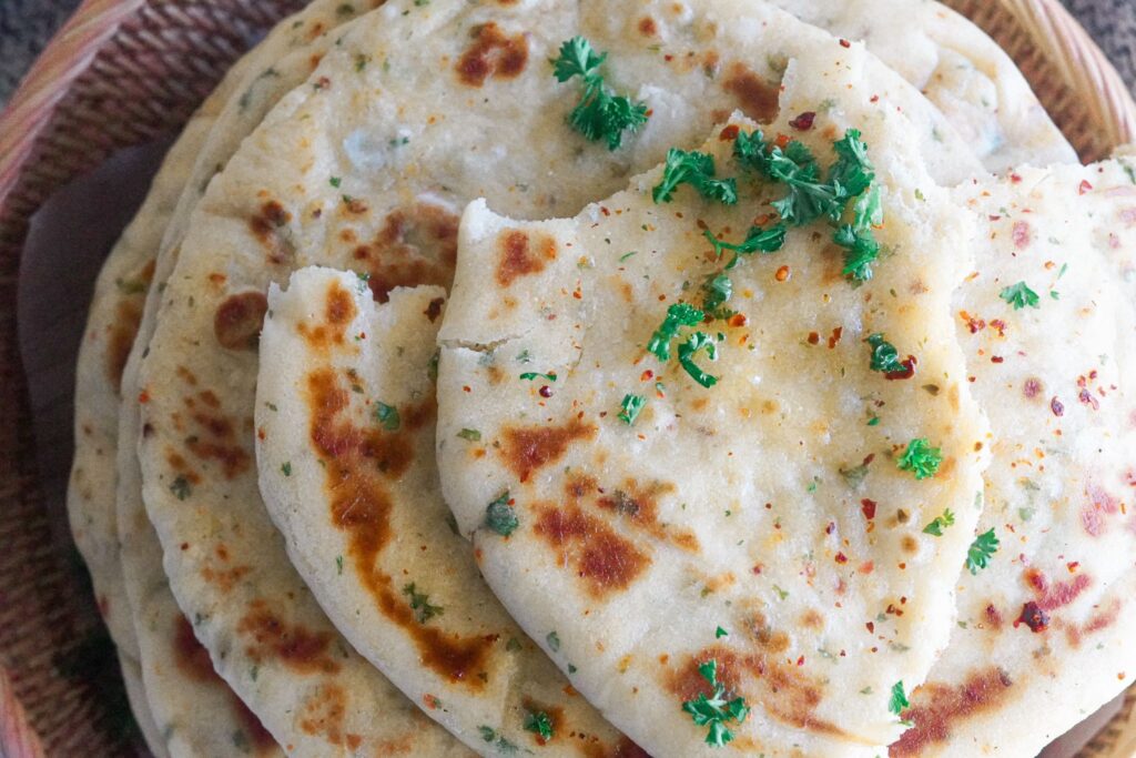 Bazlama bread featuring beautiful charred spots from the cooking process, adding to its visual appeal.