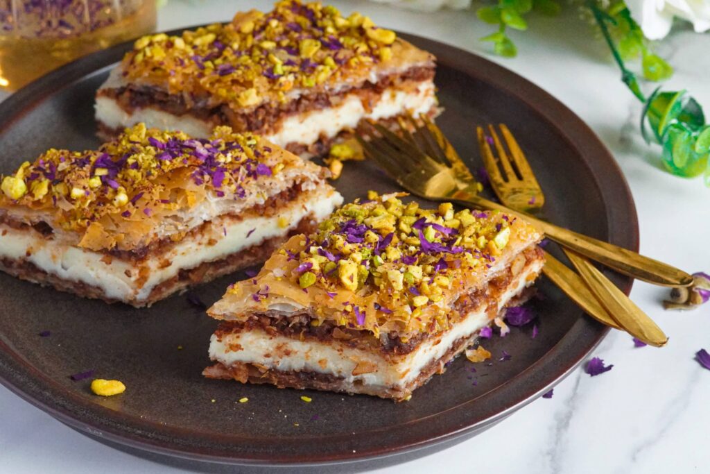 mini baklava cheesecake served with chopped pistachios and rose petals