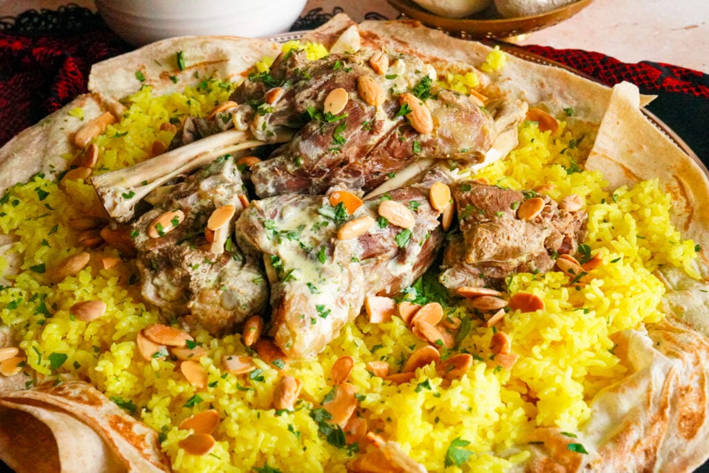 Mansaf from Jordan! A delectable yogurt-based dish accompanied by fluffy yellow rice, shrak bread, and lamb.