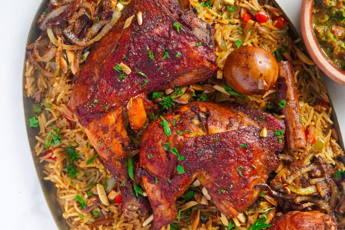 Yemeni smoked chicken served on top of fluffy rice decorated with finely chopped fresh parsley