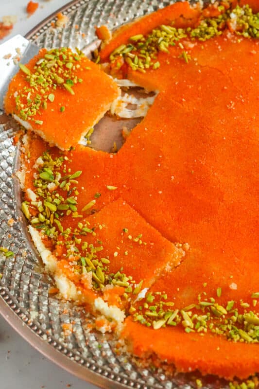 Palestinian knafeh na'ameh with browned semolina, melted cheese, and shredded pistachios