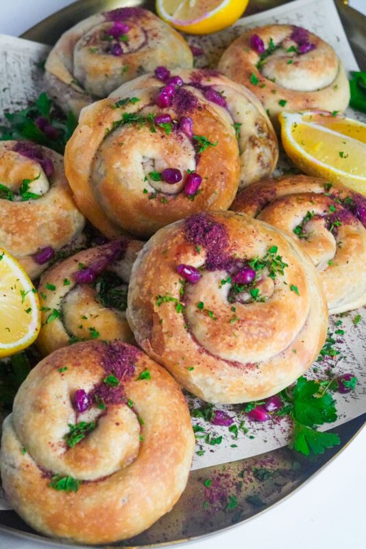 Sfeeha yafawiyeh baked to golden perfection served with lemon slices on the side