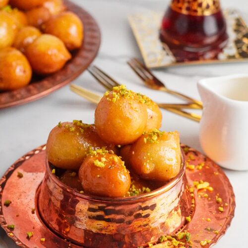 Luqaimat are deep-fried pastries dipped in simple syrup. They're crunchy on the outside and soft and airy on the inside.