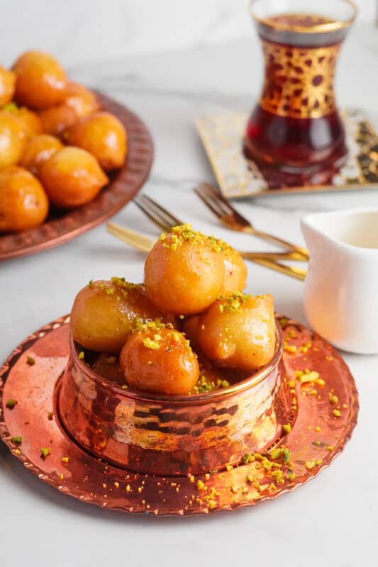 Luqaimat are deep-fried pastries dipped in simple syrup. They're crunchy on the outside and soft and airy on the inside.