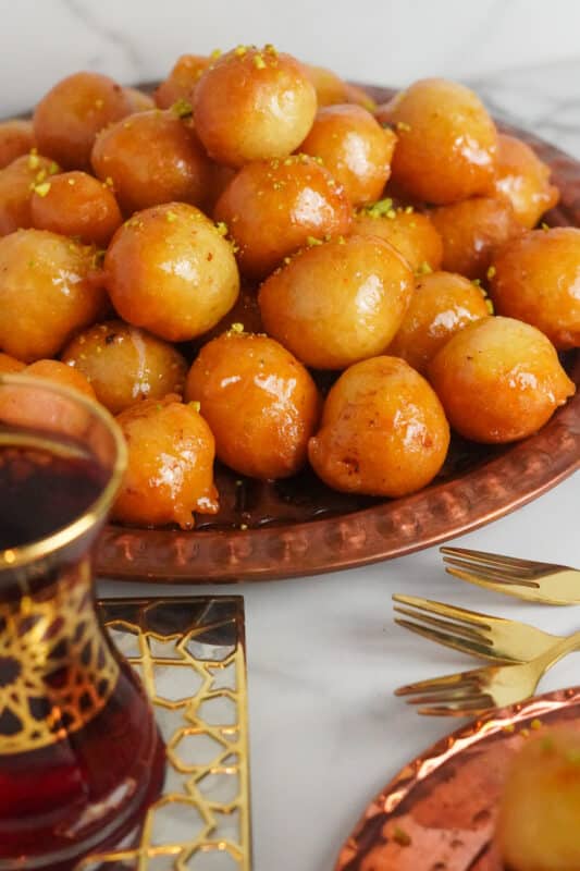 These light and crispy awameh balls are an extremely delightful Middle Eastern dessert drizzled with simple sweet syrup and served with a cup of tea.