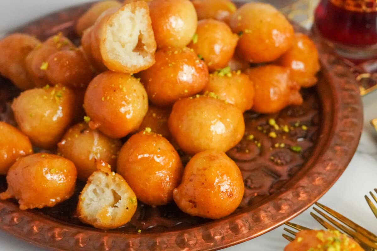 Awameh balls, a Middle Eastern delight, taste fantastic drizzled with orange blossom simple syrup and served fresh.