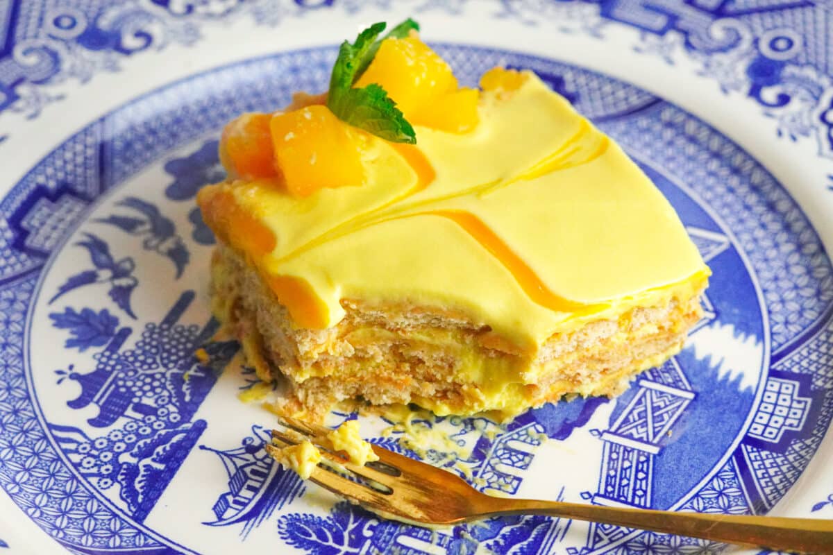 a square piece of a no bake mango cheesecake without gelatin