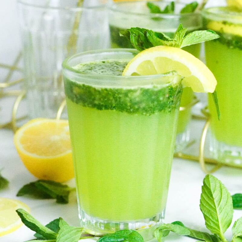 lemon juice, mint, sugar, and ice are blended together for a fresh lemonade drink