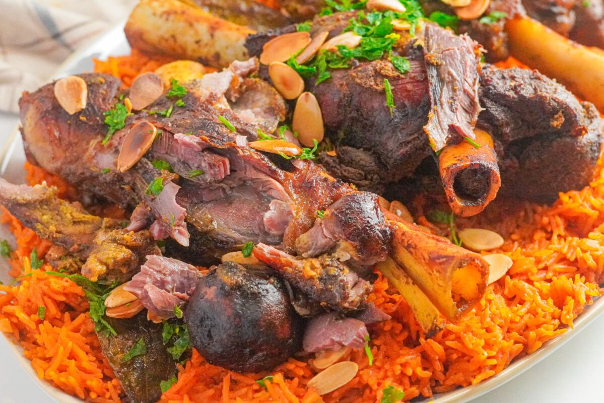 Yemeni Lamb haneeth served on a bed of rice, topped with toasted almonds.
