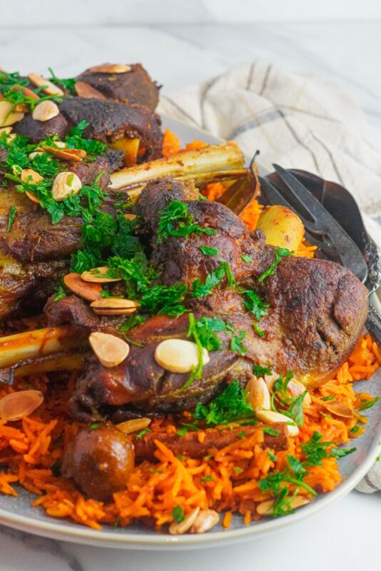 Slow cooked, juicy lamb, served with orange rice, topped with chopped parsley and almonds.