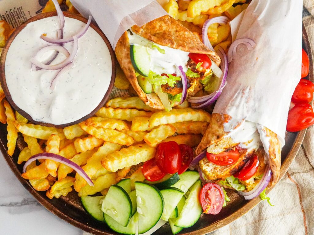 chicken gyros with tzatziki sauce served with French fries