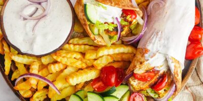 chicken gyros with tzatziki sauce served with French fries