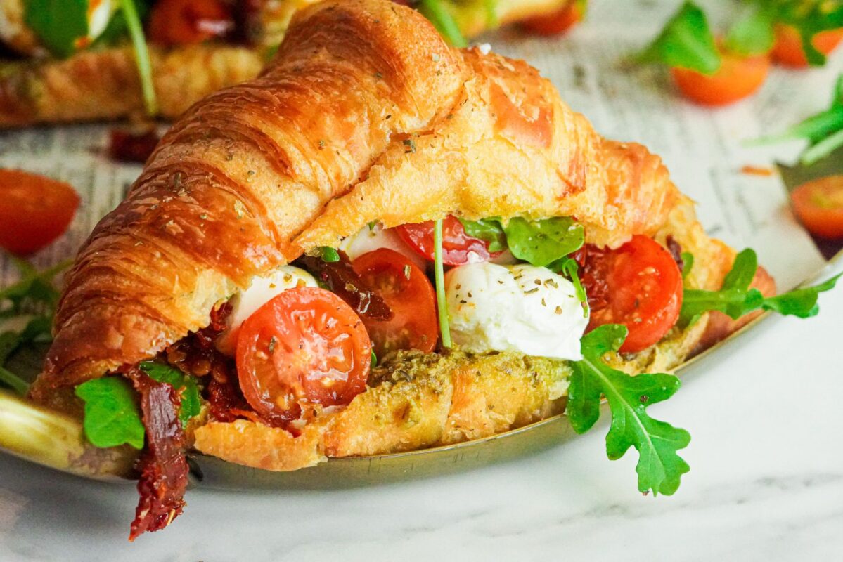 flaky croissant stuffed with pesto sauce, sundried and fresh tomatoes, fresh greens, and mozzarella cheese