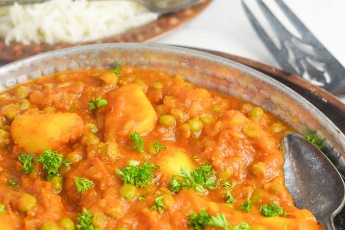 Vegan Pakistani comfort food consisting of creamy potatoes and green peas
