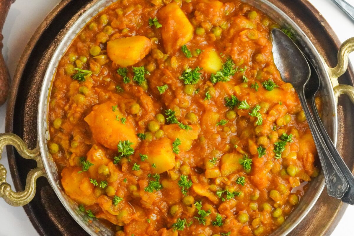Aloo Matar, a classic vegetarian comfort food that is popular in Pakistan served with finely chopped parsley