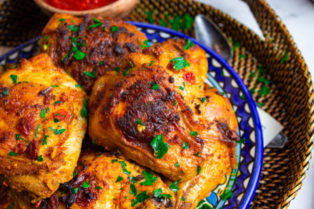 Golden crispy Harissa garlic chicken served on top of Turkish bulgur pilaf dish