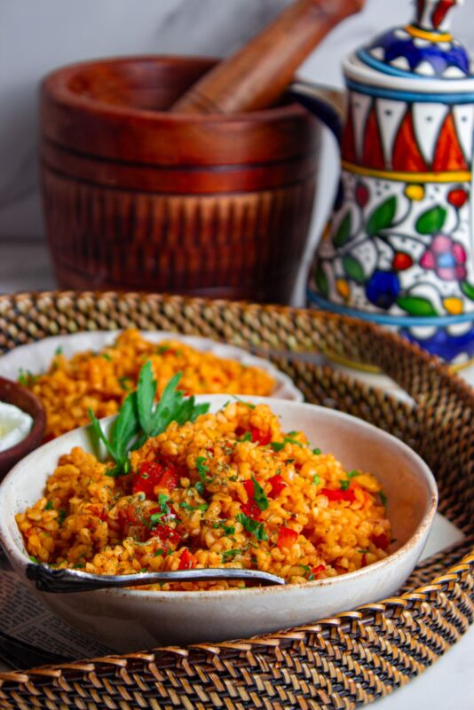 two dishes of Turkish bulgur pilaf served with fresh parsley on top