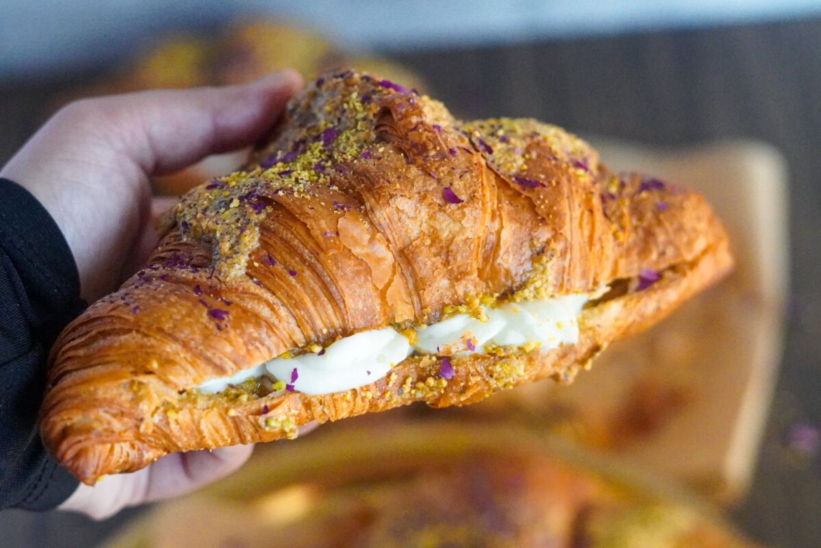 creamy ashta with pistachio paste stuffed in a large croissant