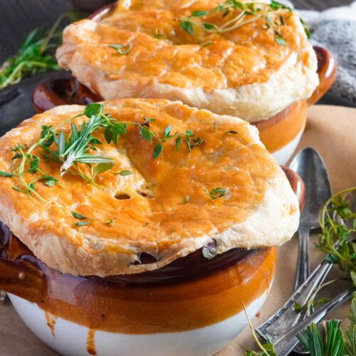 two pots of chicken pie served warm with fresh rosemary on top