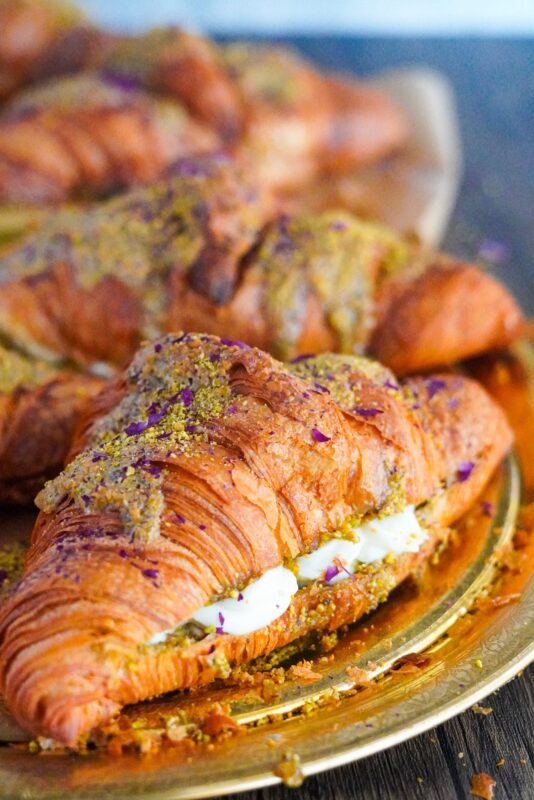 A large flakey croissant stuffed with sweet quashta and Middle Eastern creamy paste
